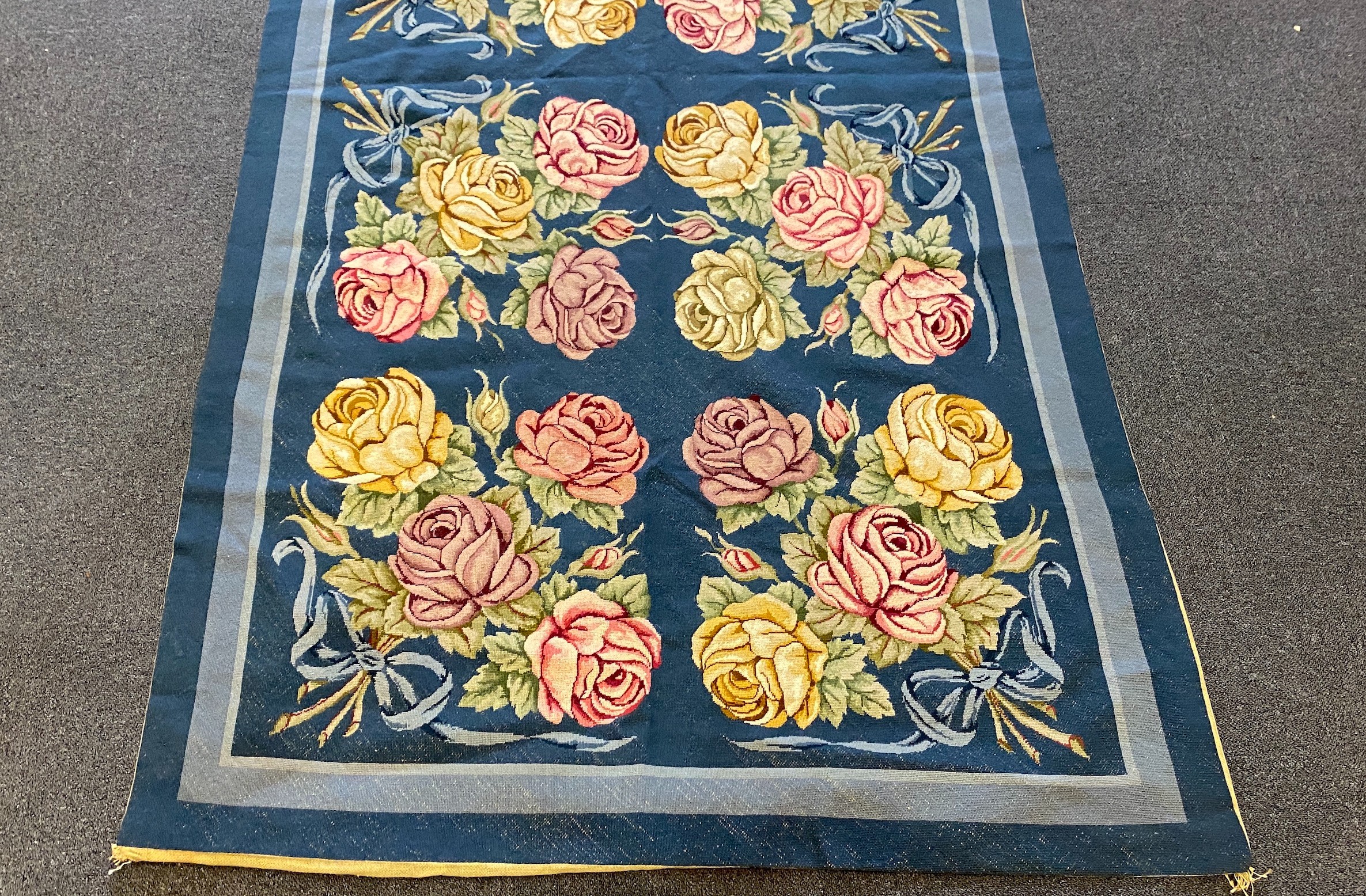 An English needlepoint blue ground carpet, 252 x 125cm